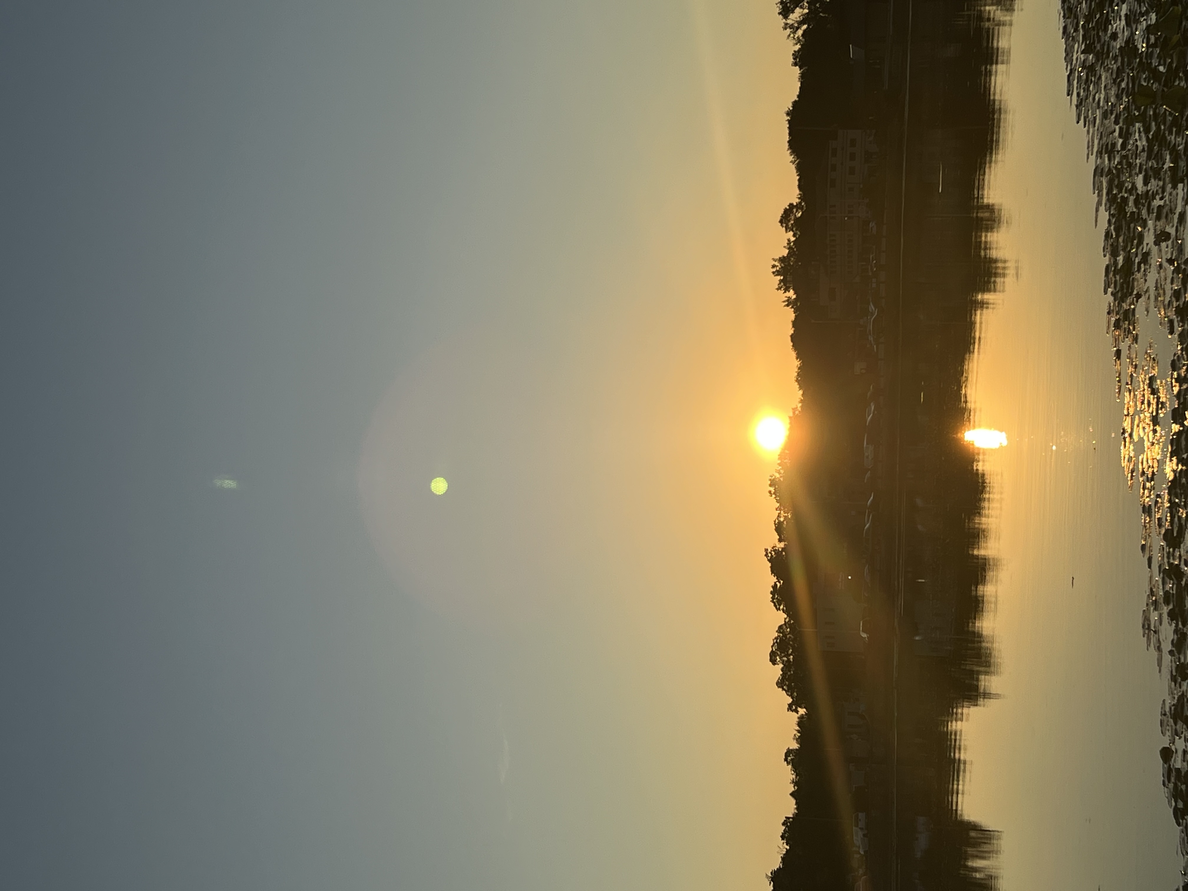 Sunset over the Fox River with a pedestrian bridge and riverwalk